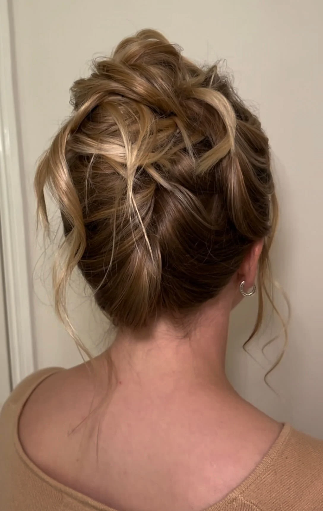 A messy, loose textured bridal updo idea created on long, blonde hair.