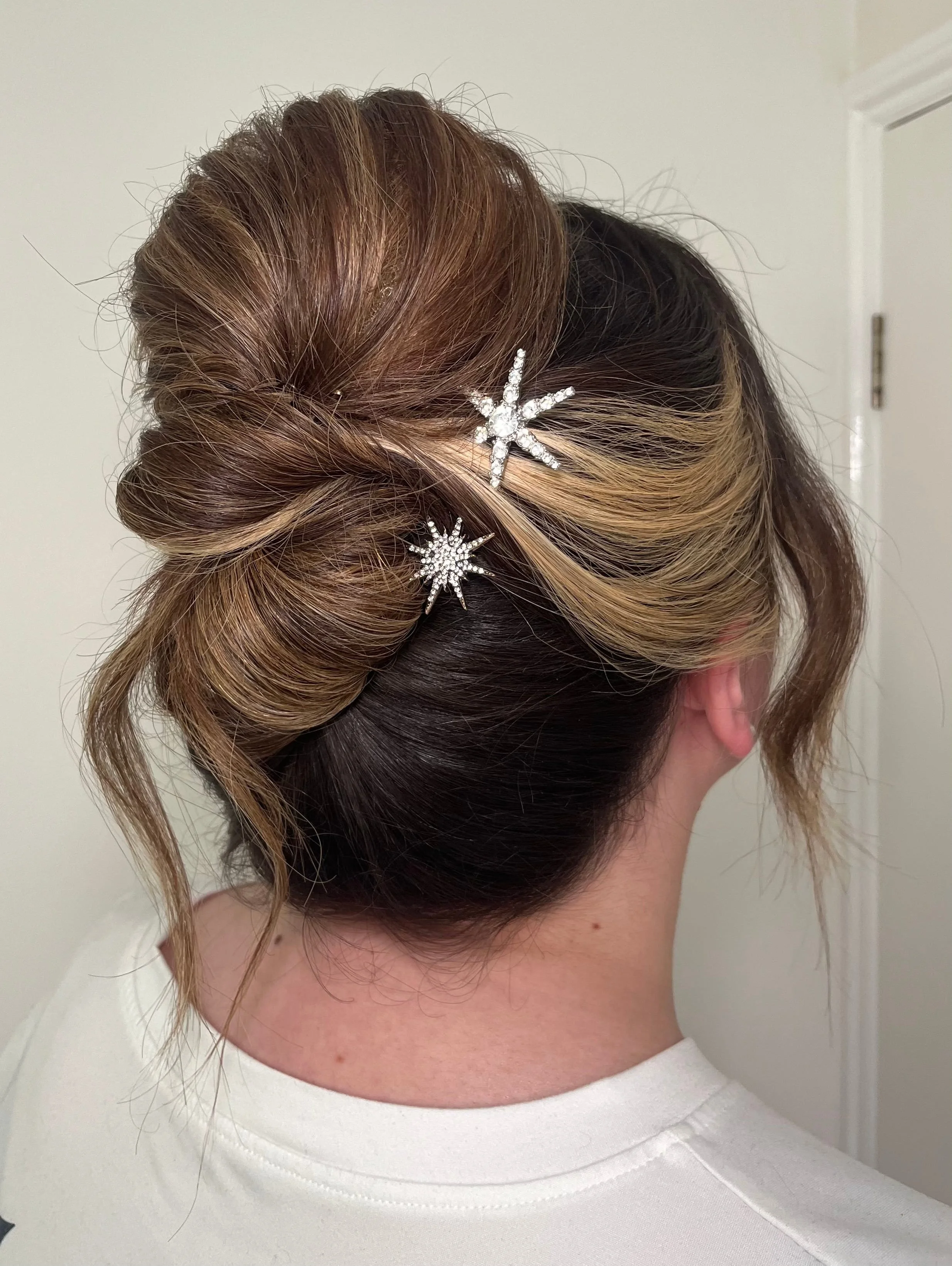 A modern looking high bridal updo idea, created on multi-tonal highlighted hair.