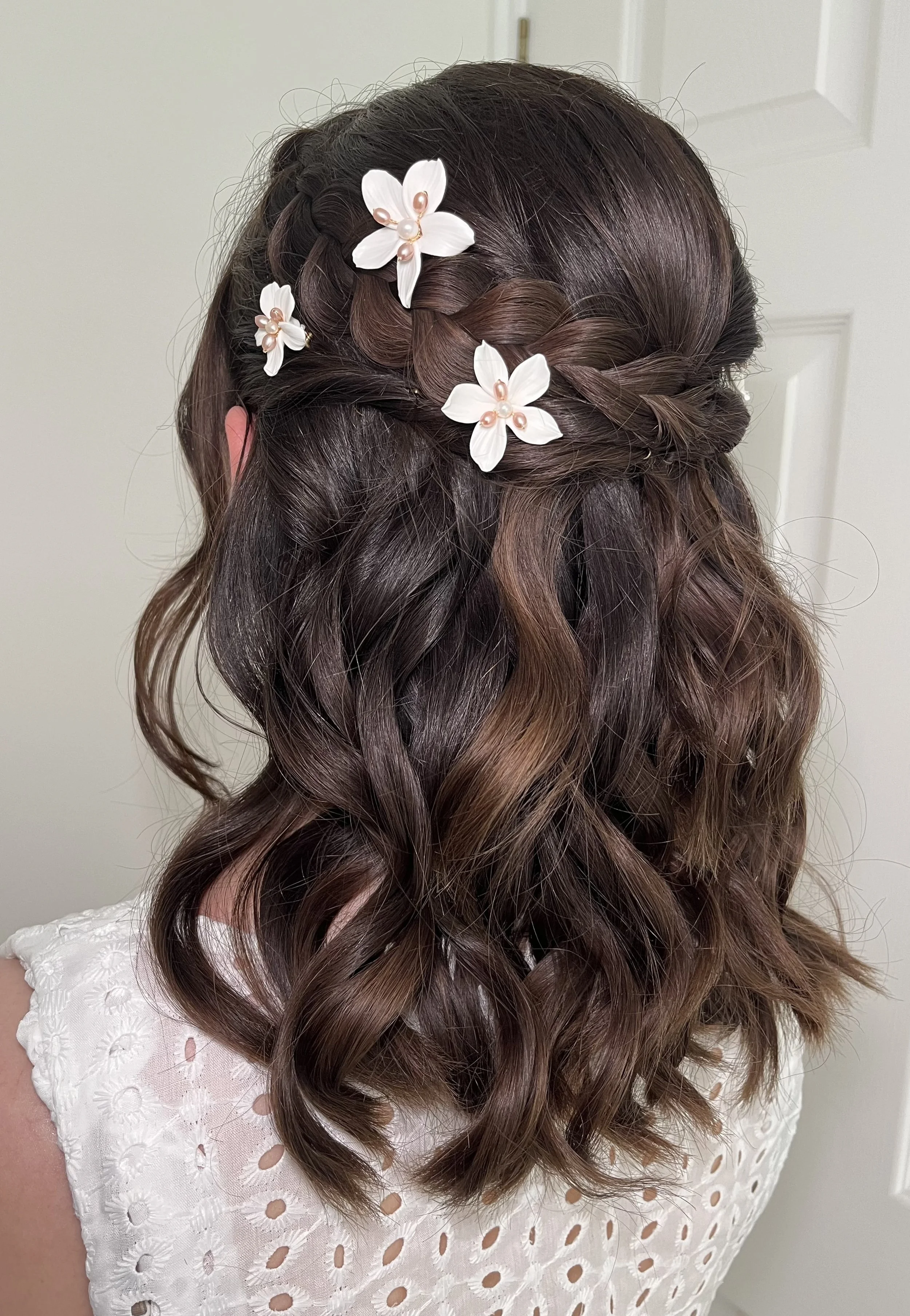 A bride wearing her hair in a half up half down hairstyle with a braid, ready for her wedding at Little Channels in Chelmsford.