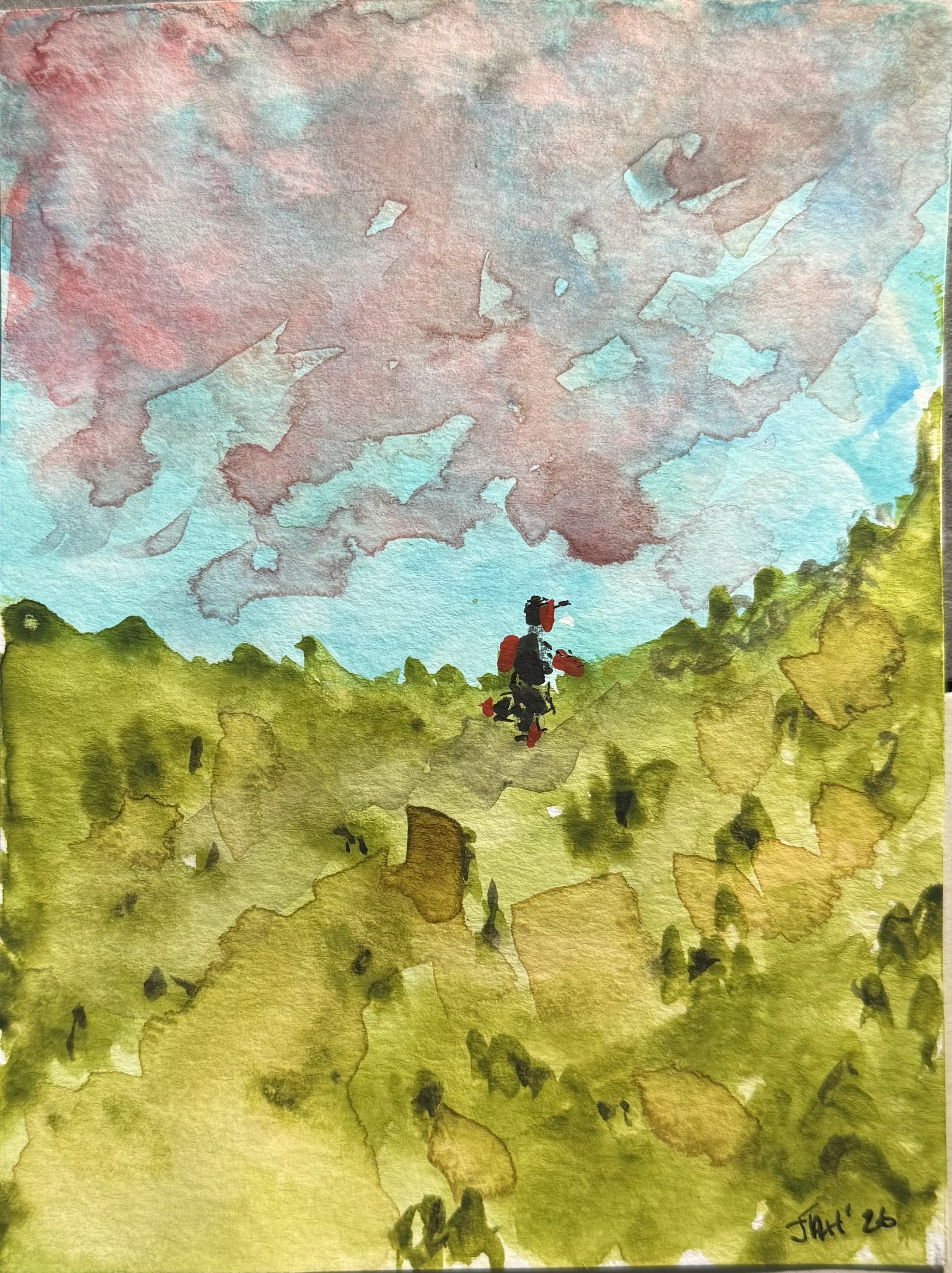 Watercolor painting depicting a person sitting on the grass, facing away, with mountains and colorful sky in the background.