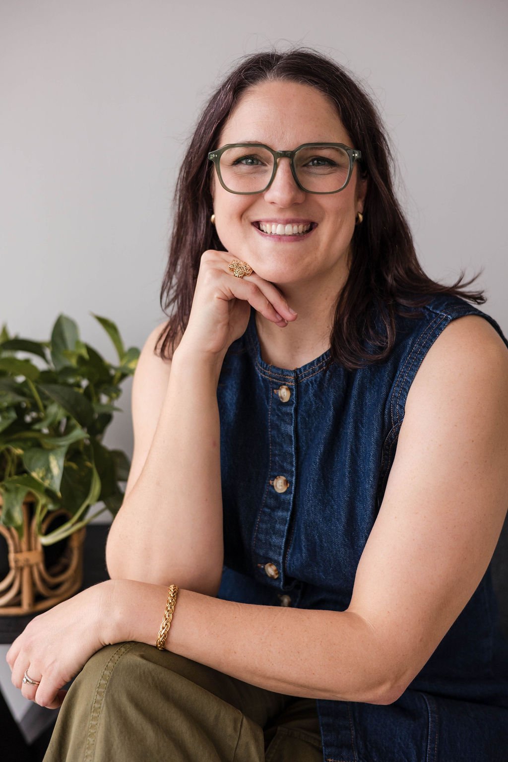 Erin Kehrier, LCSW, IFS and EMDR intensive therapist serving adults with ADHD and complex trauma in Texas and Michigan, smiling warmly with chin resting on hand
