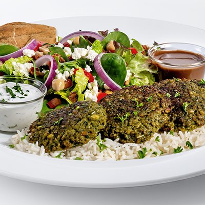 a photo of the baked falafel feast showing several pieces of falafel atop a bed of basmati rice with a small side salad