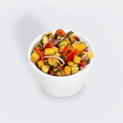 photo of a small white bowl filled with a blend of grilled squash, zucchini, onions, and red peppers