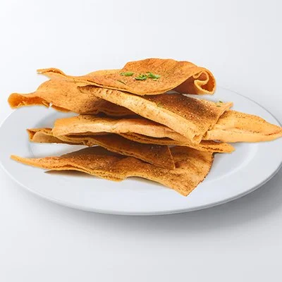 a photo of a small white plate piled with eight triangular pieces of golden-brown baked pita chips
