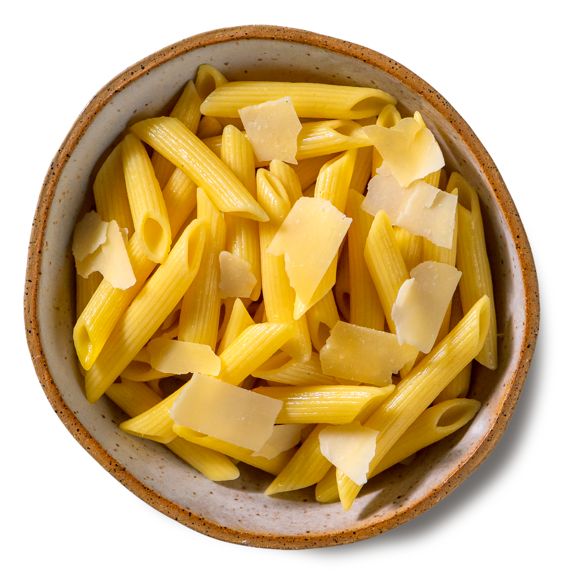An overhead photo of a rustic handmade pottery bowl filled with cooked penne pasta, topped with shavings of parmesan cheese