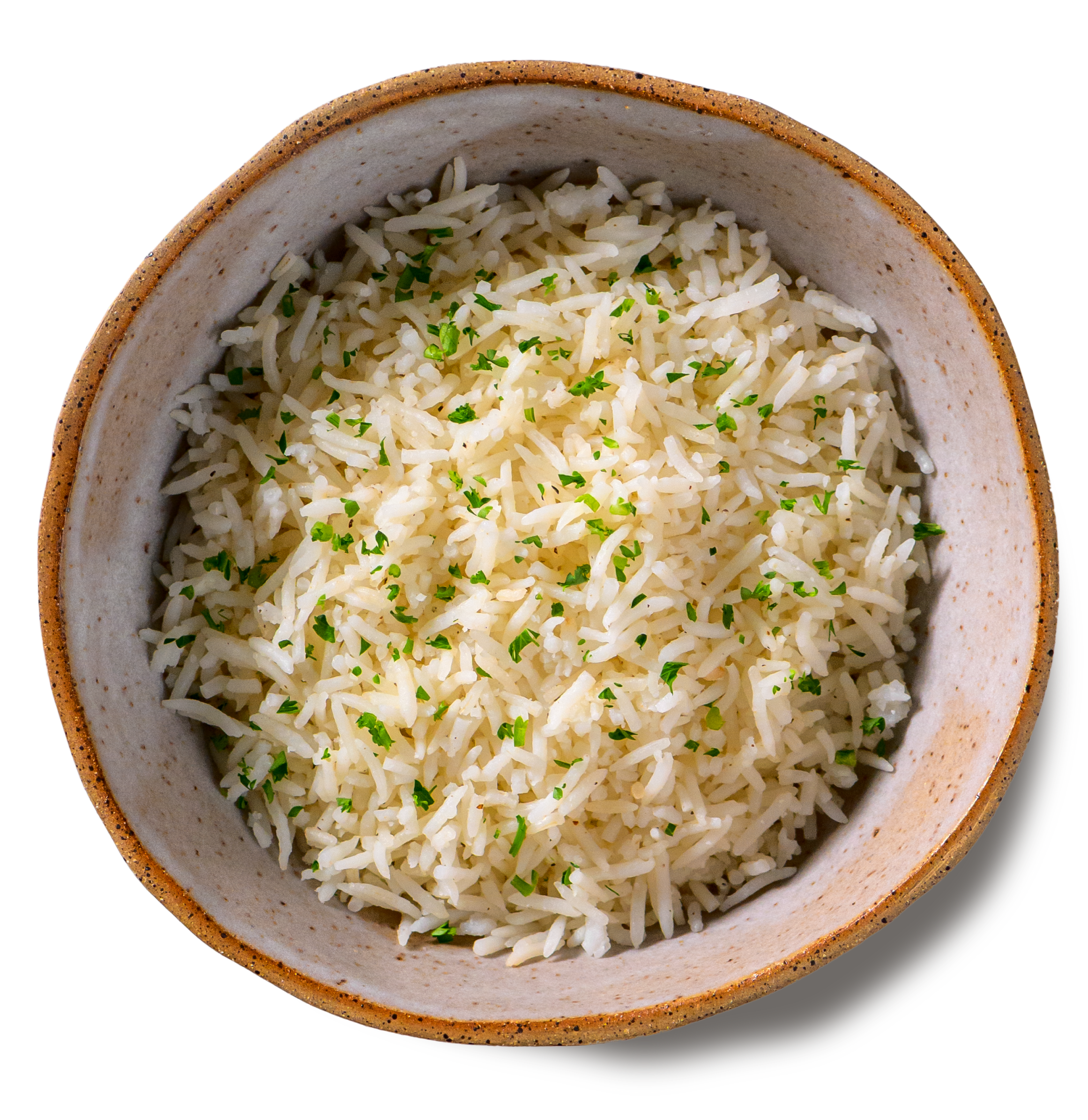 An overhead photo of a rustic handmade pottery bowl filed with fluffy grains of basmati rice, topped with a sprinkle of chopped parsley