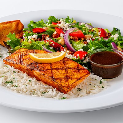 A photo of the grilled salmon feast, showcasing a chargrilled filet of salmon on a bed of basmati rice with a small side salad