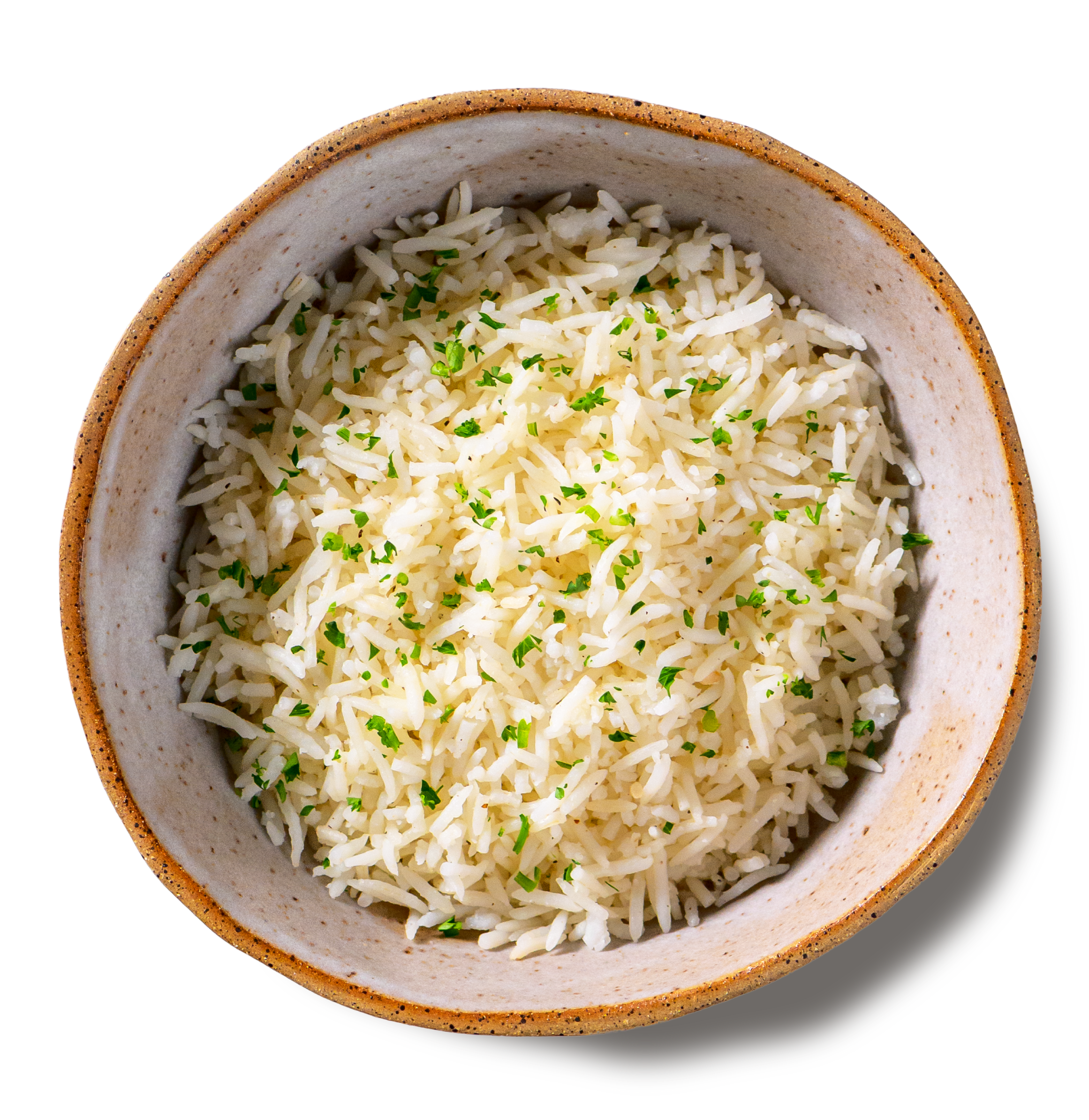 An overhead photo of a rustic handmade pottery bowl filed with fluffy grains of basmati rice, topped with a sprinkle of chopped parsley