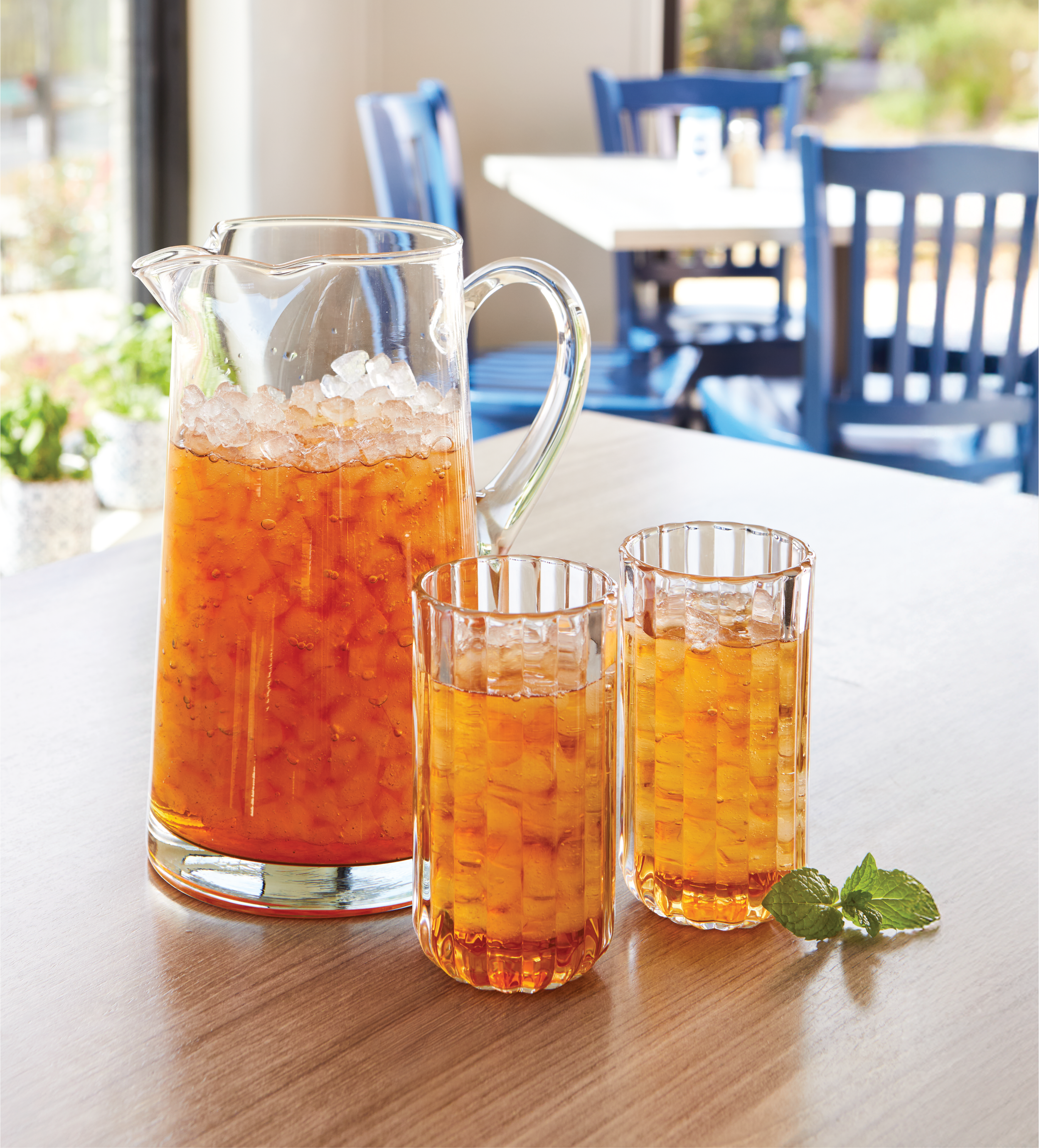 A photo of a pitcher and two glasses filled with refreshing Mint Iced Tea