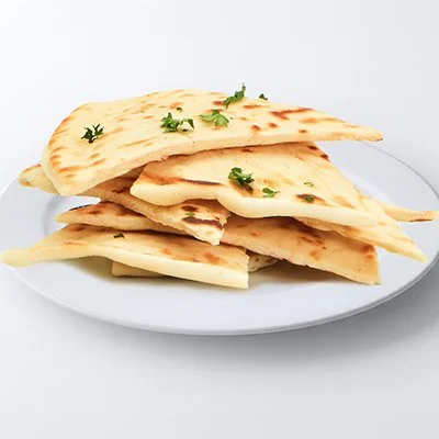 a photo of a small white plate piled with 8 triangular pieces of pita bread