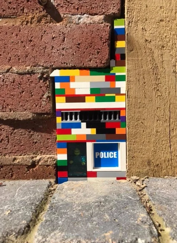 Poorly installed brickwork, cleverly enhanced using LEGO bricks to fill the space and enhance the unique look of the wall.