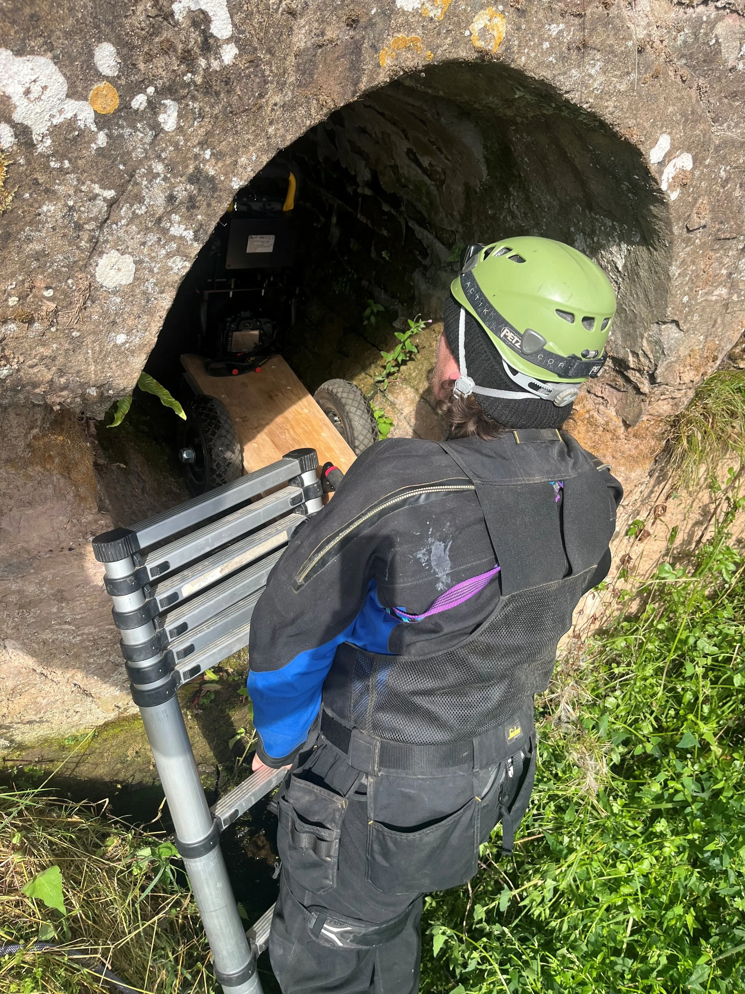 Corey Lane delivering a specialist presentation for the Channel 4  programme, Saving Country Houses with Penelope Keith, including the confined space entry of a 17th Century culvert and its structural assessment.