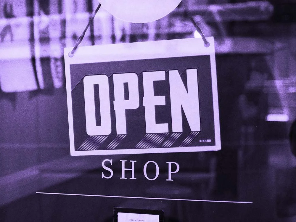 An "OPEN SHOP" sign hangs in a window.