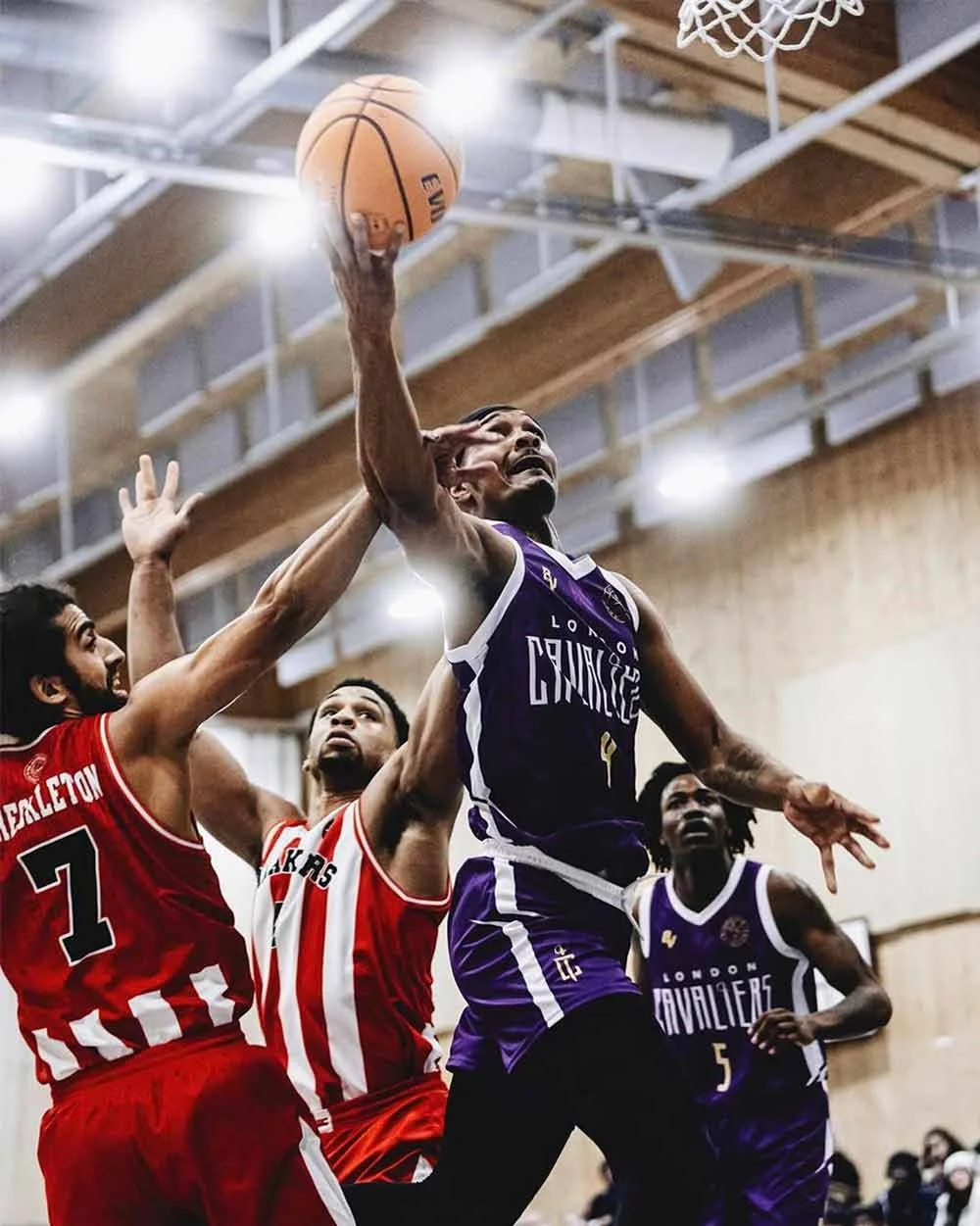 basketball-player-dunking-against-defenders.jpg