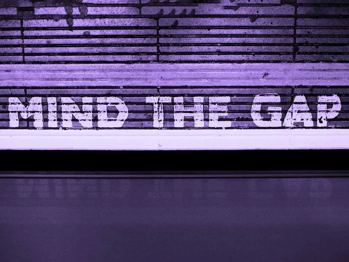 White text on a purple background reads "MIND THE GAP".