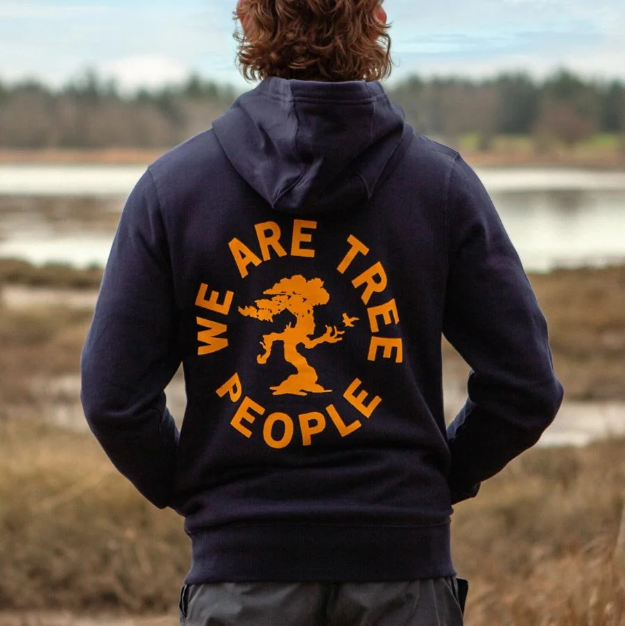 Person wearing a hoodie with text 'We Are Tree People' and a tree graphic.