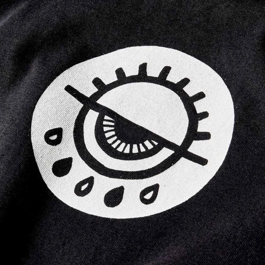 Stylized eye with tears on black fabric