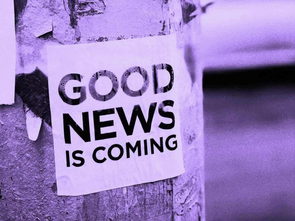 A paper sign attached to a pole reads "GOOD NEWS IS COMING".