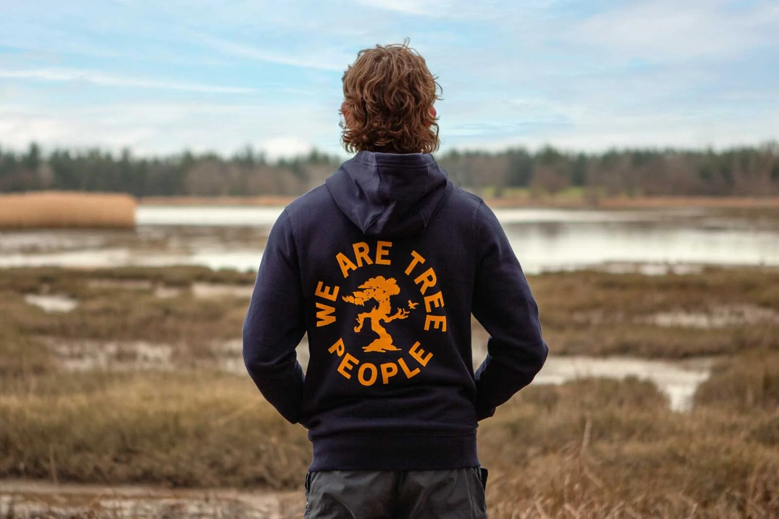 Person wearing a hoodie with text 'We Are Tree People' and a tree graphic.