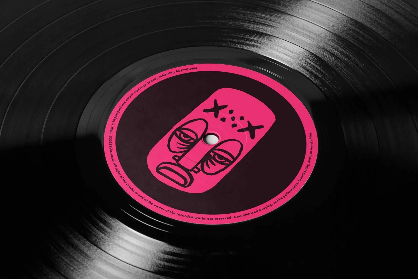 A black vinyl record with a pink label featuring a stylized, abstract face.