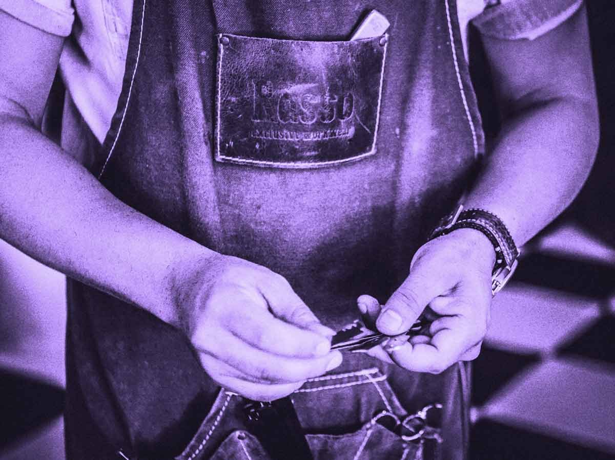 A craftsman in an apron handles keys.