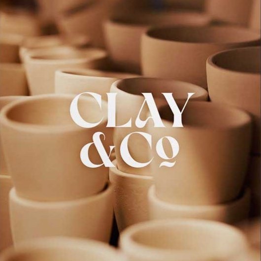 Stacked unglazed clay pots with the text 'clay & co' overlayed.