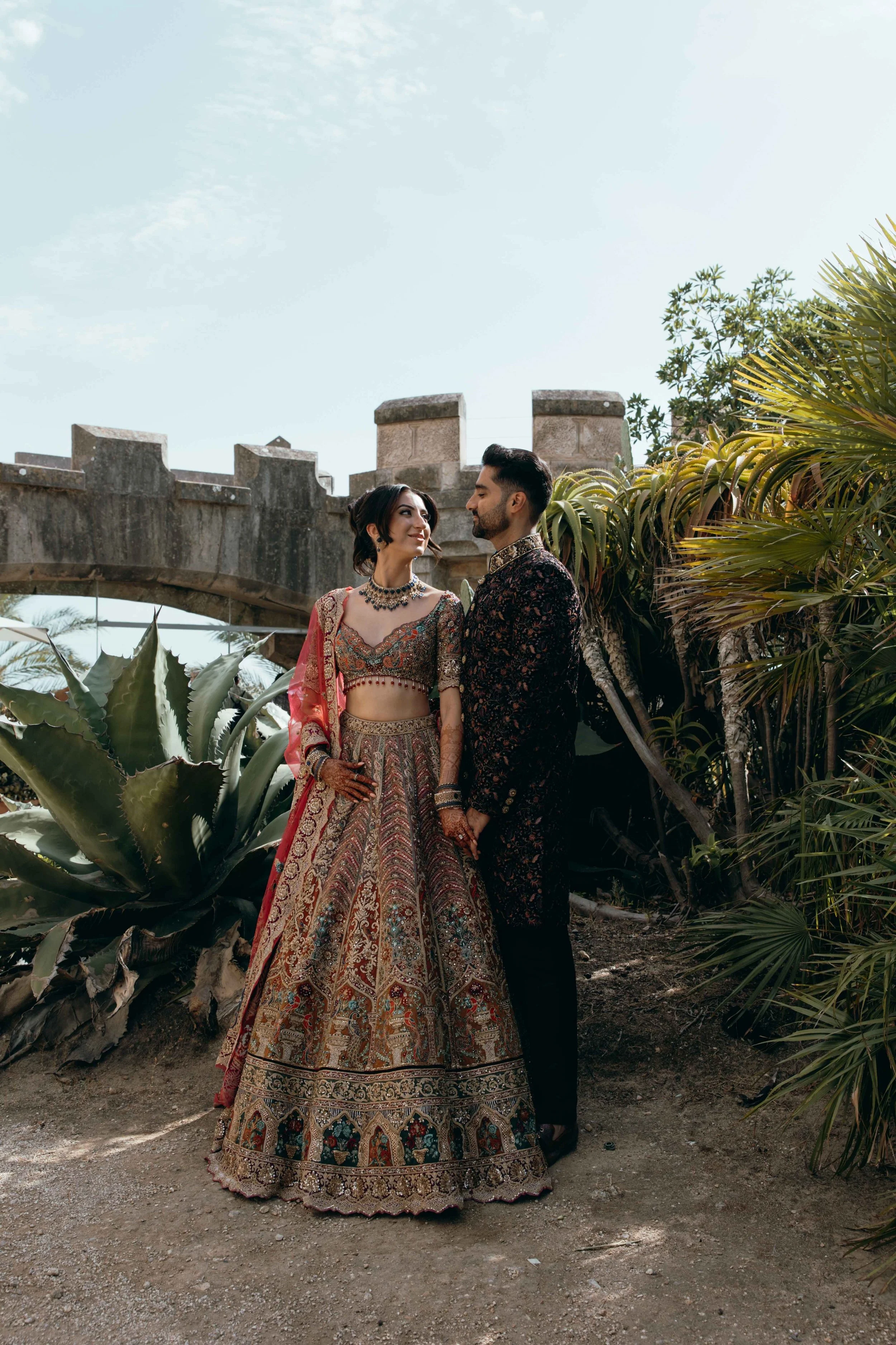 wedding couple posing in tropical gardens