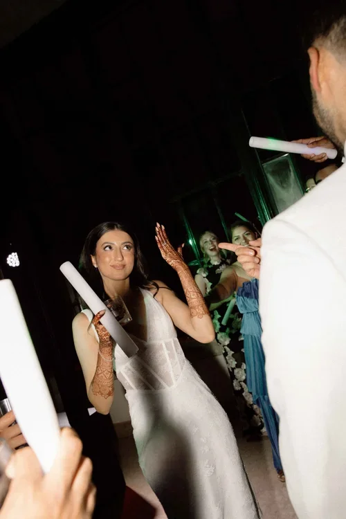 Bride showing her diamond wedding ring to guests on the dance floor at the after party