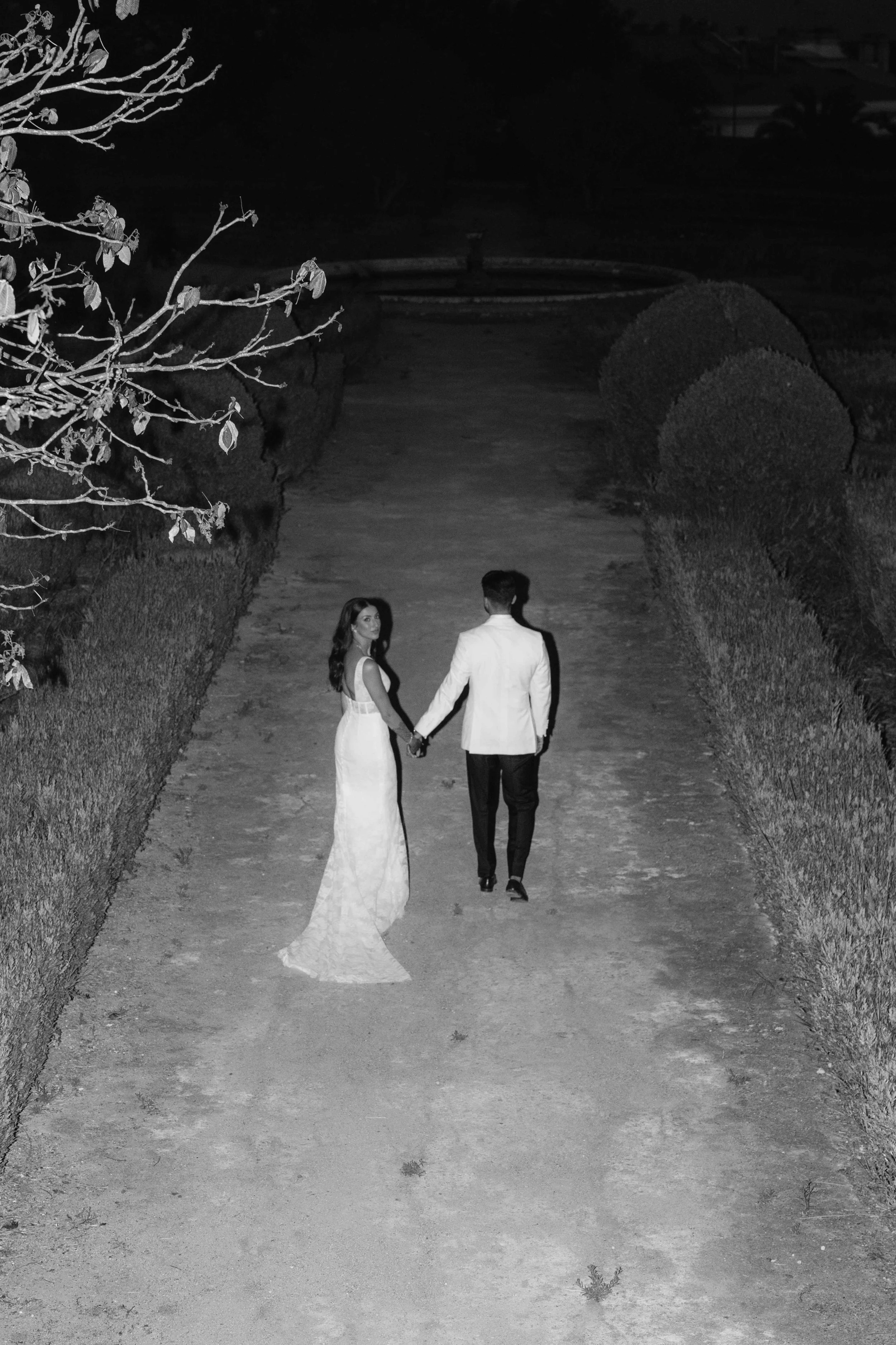 Couple holding hands at night at a Marbella wedding reception