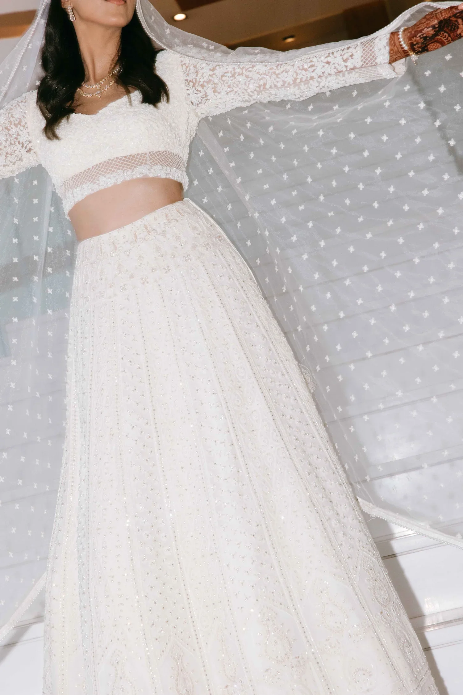 Bride twirling in an embellished white lace embroidered wedding dress at a Marbella wedding