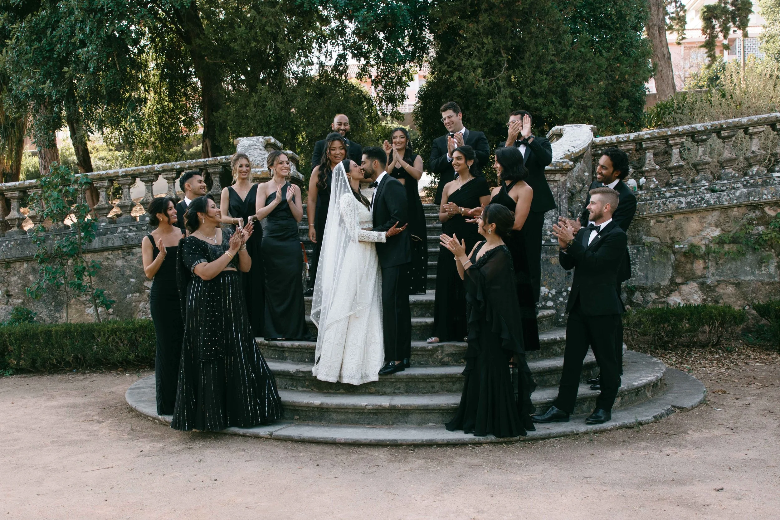 bride and groom posing with wedding party
