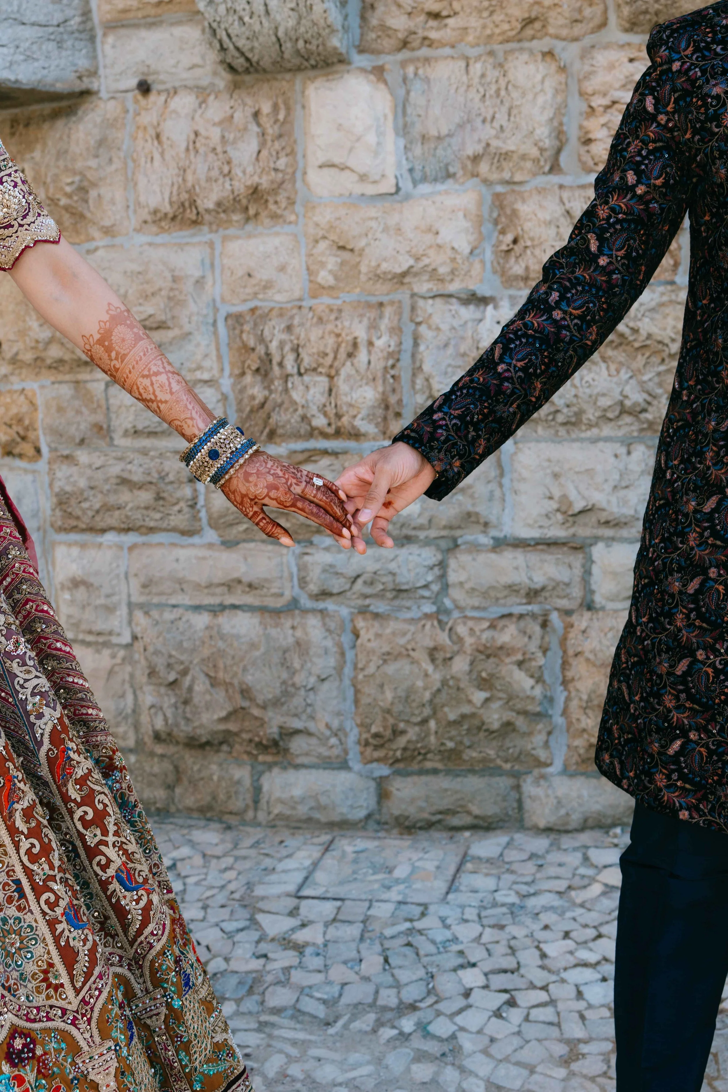 Wedding couple holding hands at a wedding reception