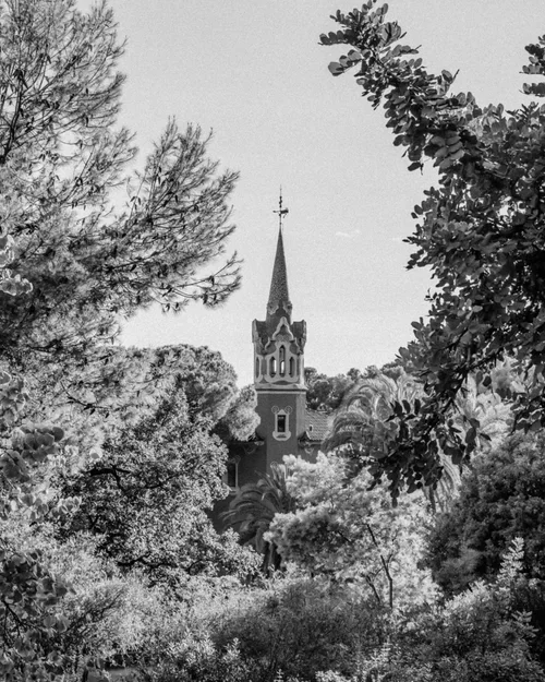 Beautiful Guadi church surrounded by trees in Park Guell Barcelona