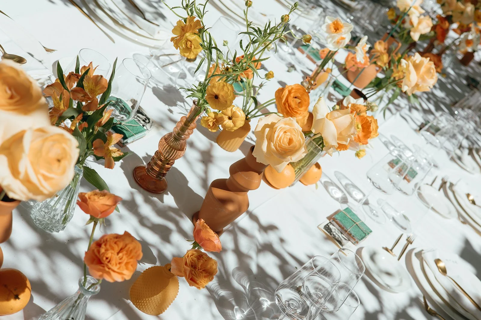 Table setting with orange flowers at a luxury Marbella wedding