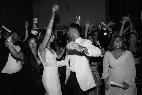 

Bride and groom dancing and celebrating with guests on the dance floor at a Marbella wedding reception