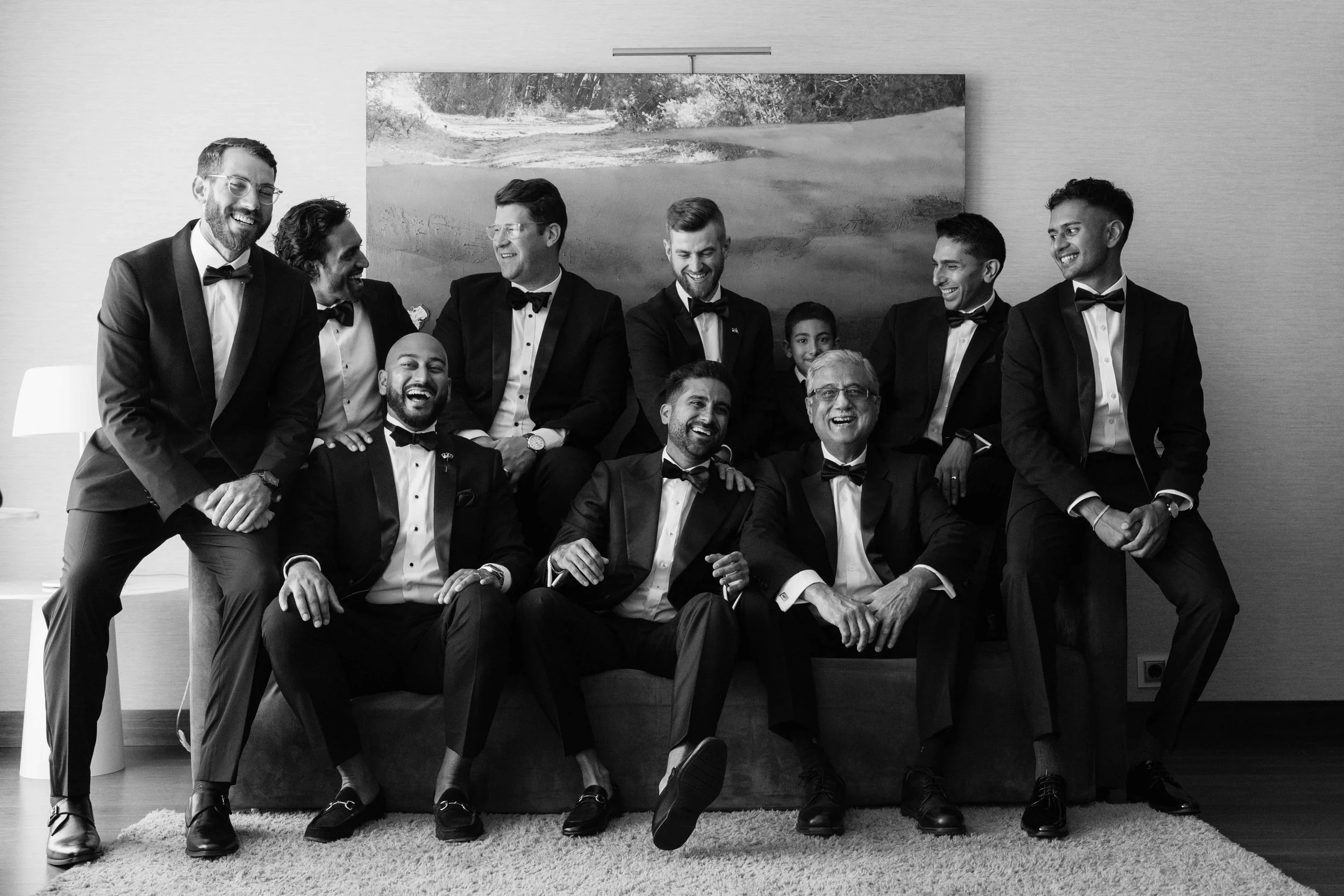 groomsmen laughing in tuxedos
