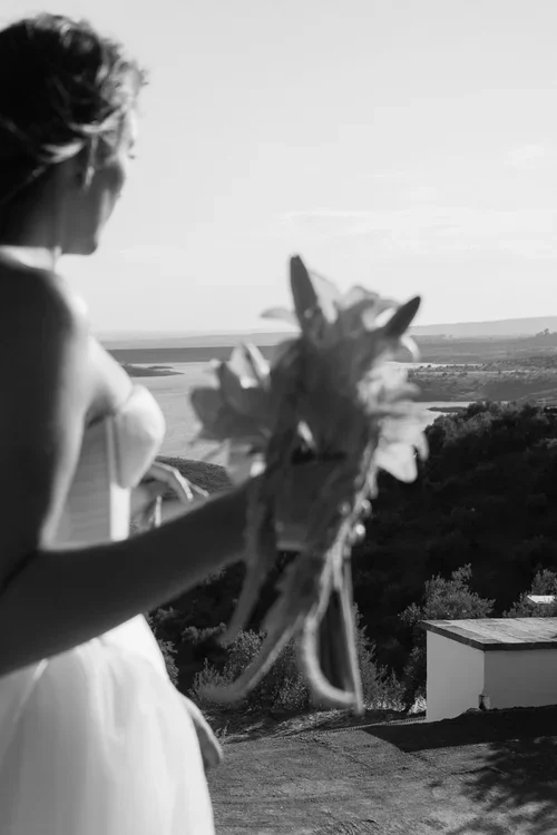  Bride holding bouquet overlooking a vast landscape from a Marbella hills viewpoint