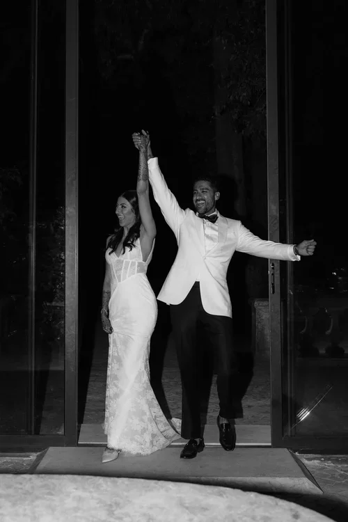 Bride and groom entering the wedding reception in formal dinner wear in Malaga