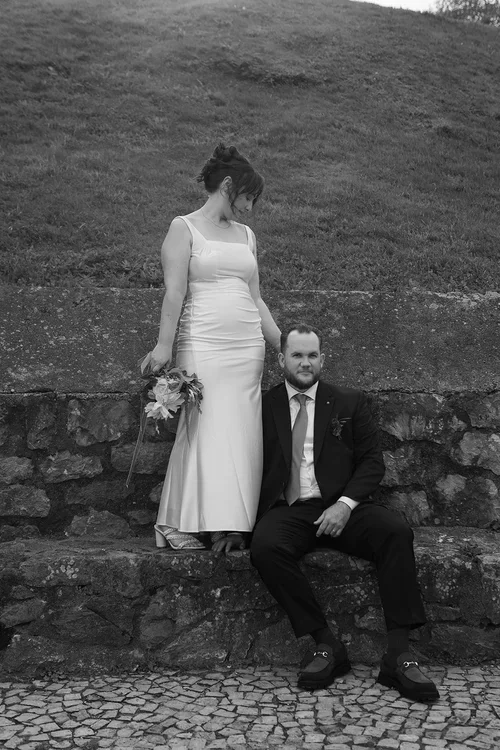 Bride and groom posing on stone steps in the hills of Malaga