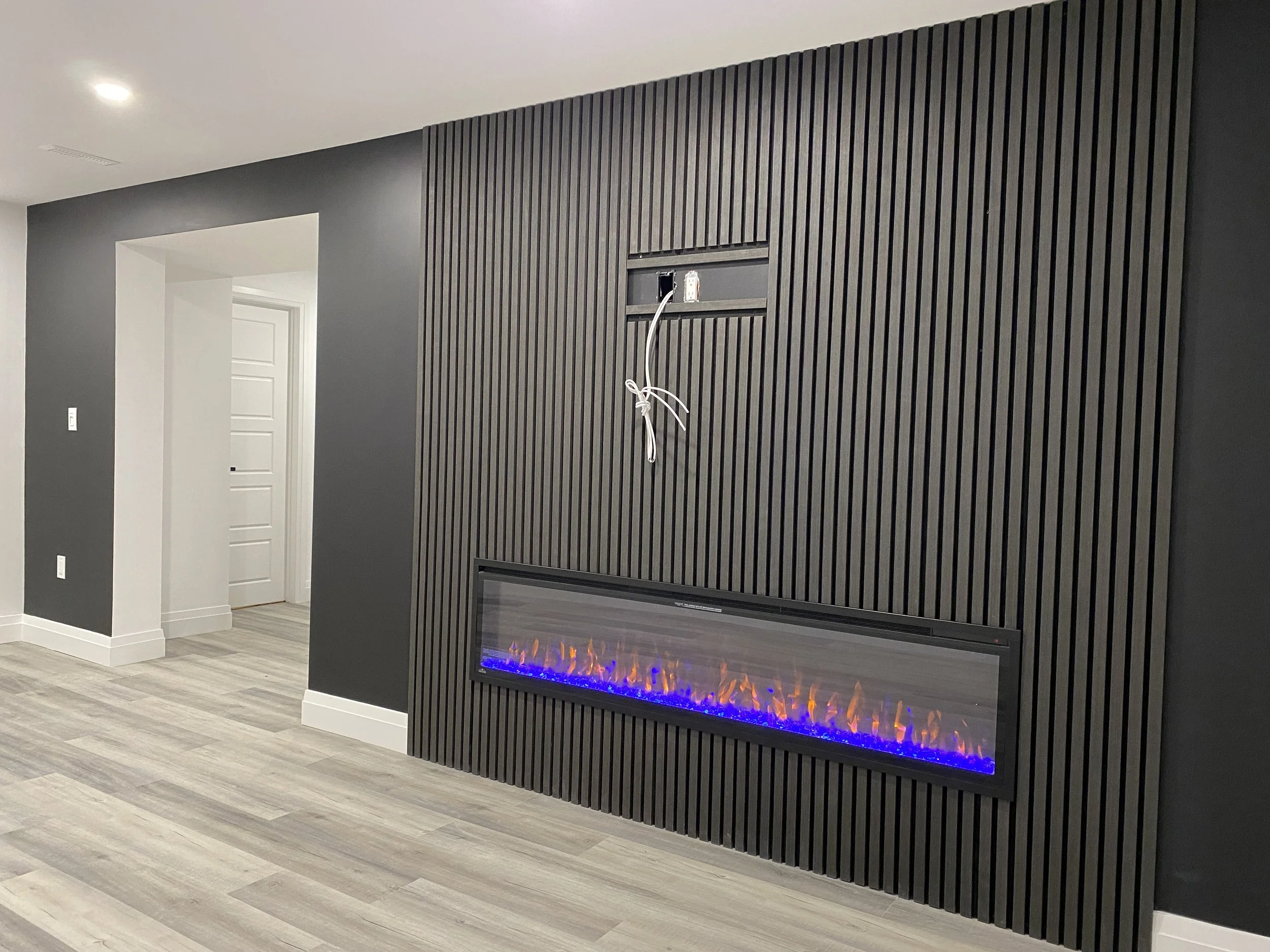 Custom Basement after Renovation - Amazing wood panel and fireplace