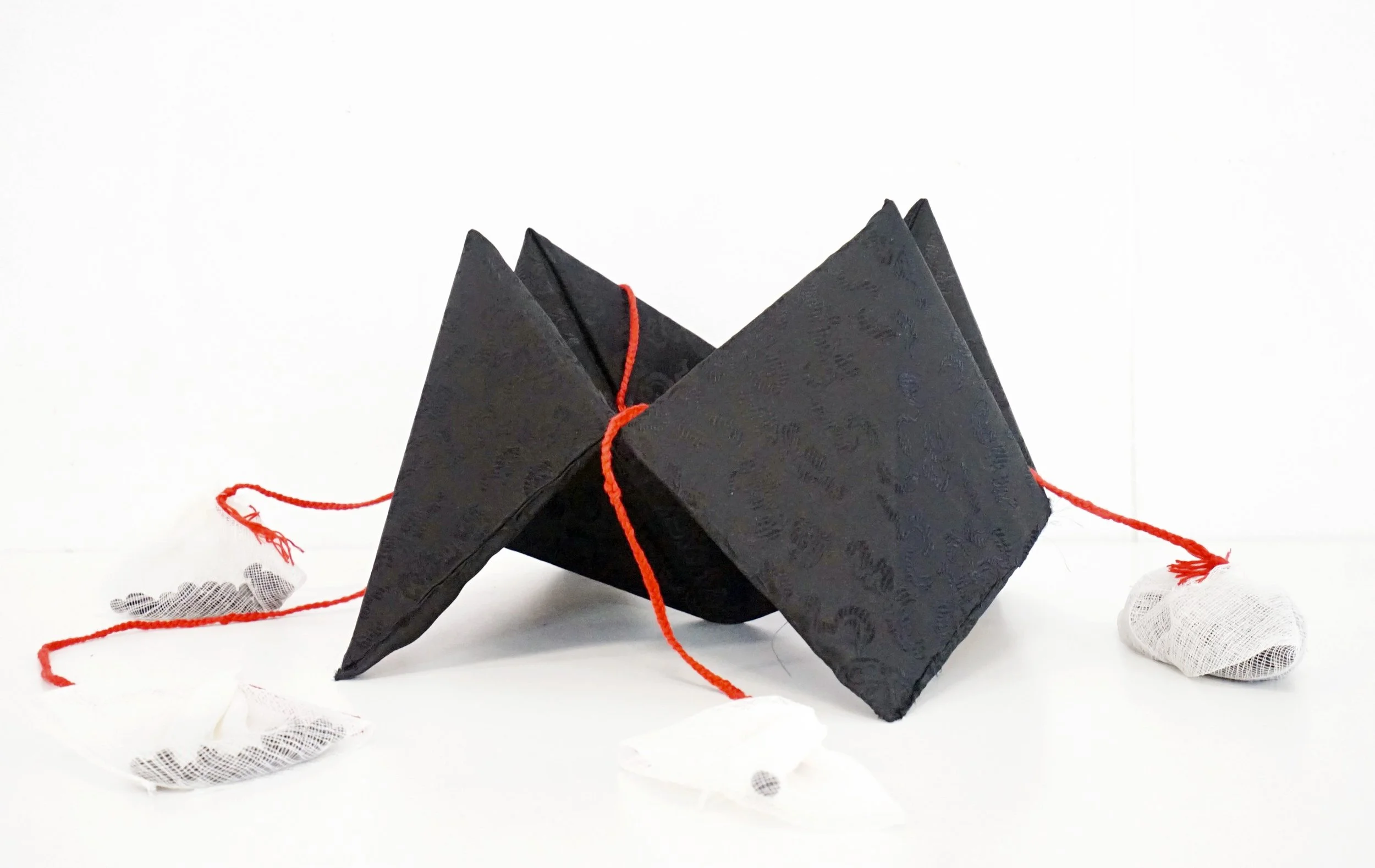 Dong Nan Xi Bei / The Fortune Teller, Fabric Wrapped on Paper, Thread and Garbanzo Beans, 16 x 16 x 8 inches, 2024