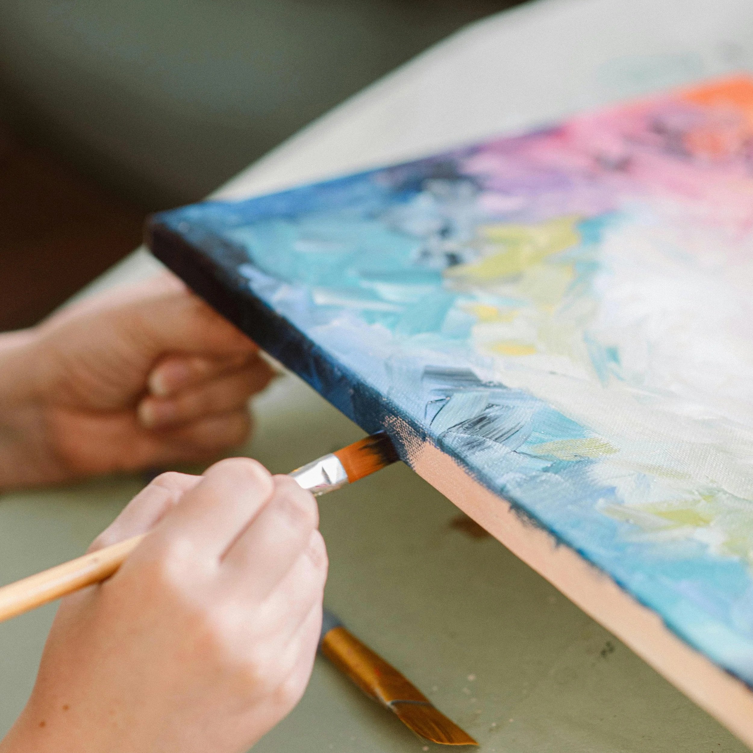 Artist painting in a studio with expressive color and visible brushwork