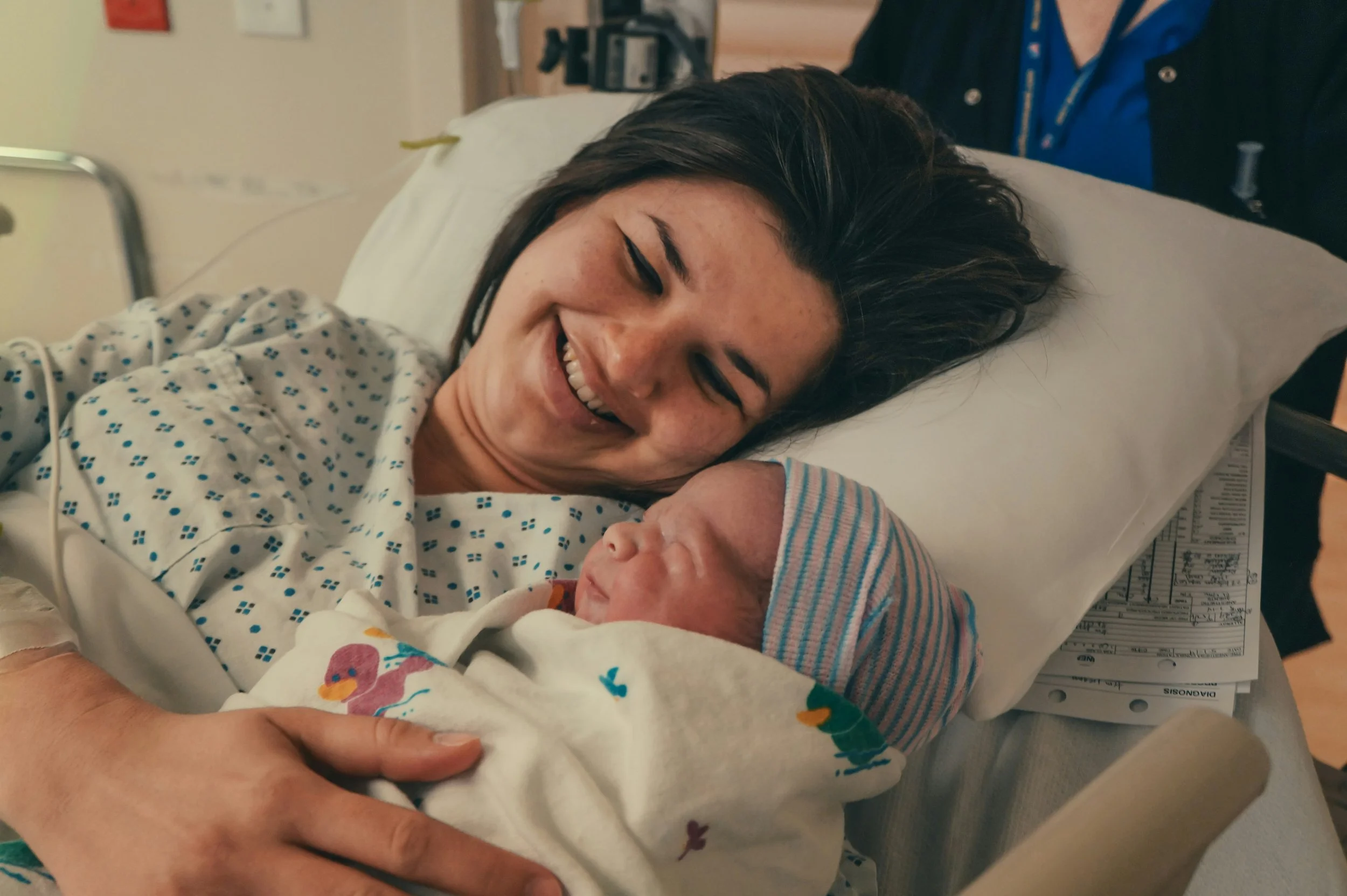  Mom holding newborn during recovery after c-section 