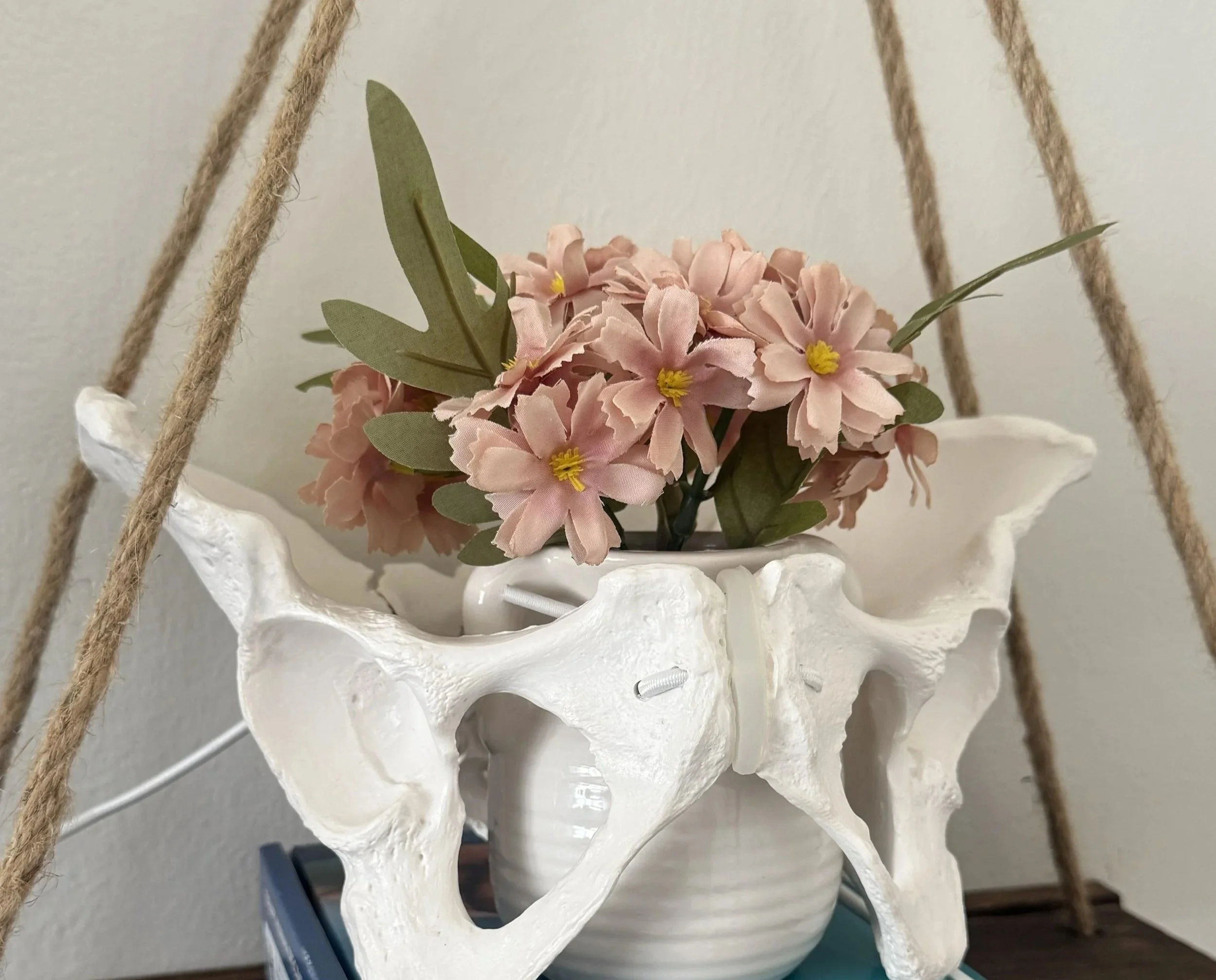 White pelvis vase with flowers