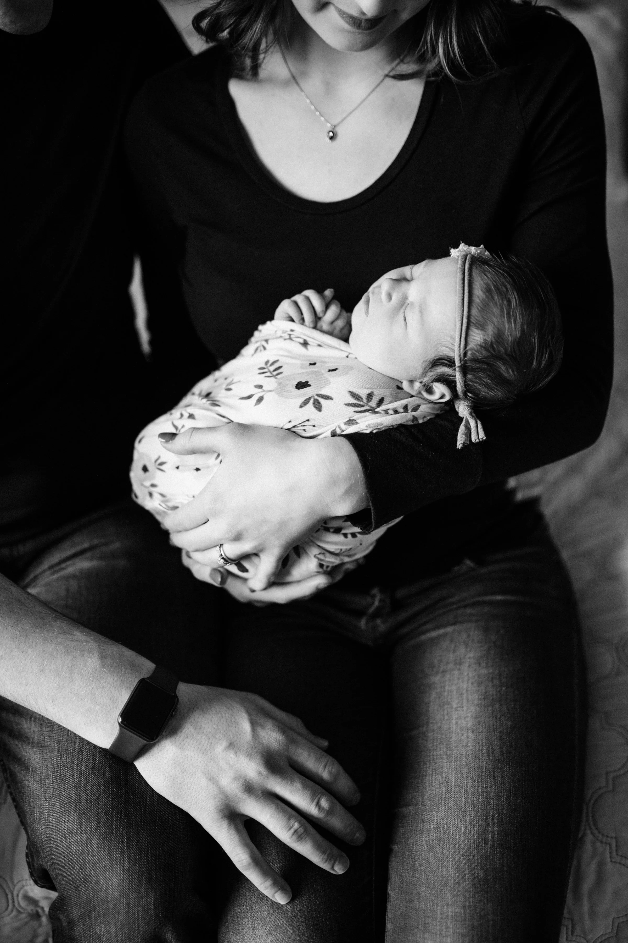 mother struggling with breastfeeding holding newborn baby in arms