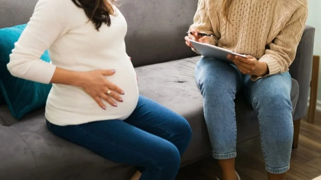 Pregnant woman discussing option to change providers