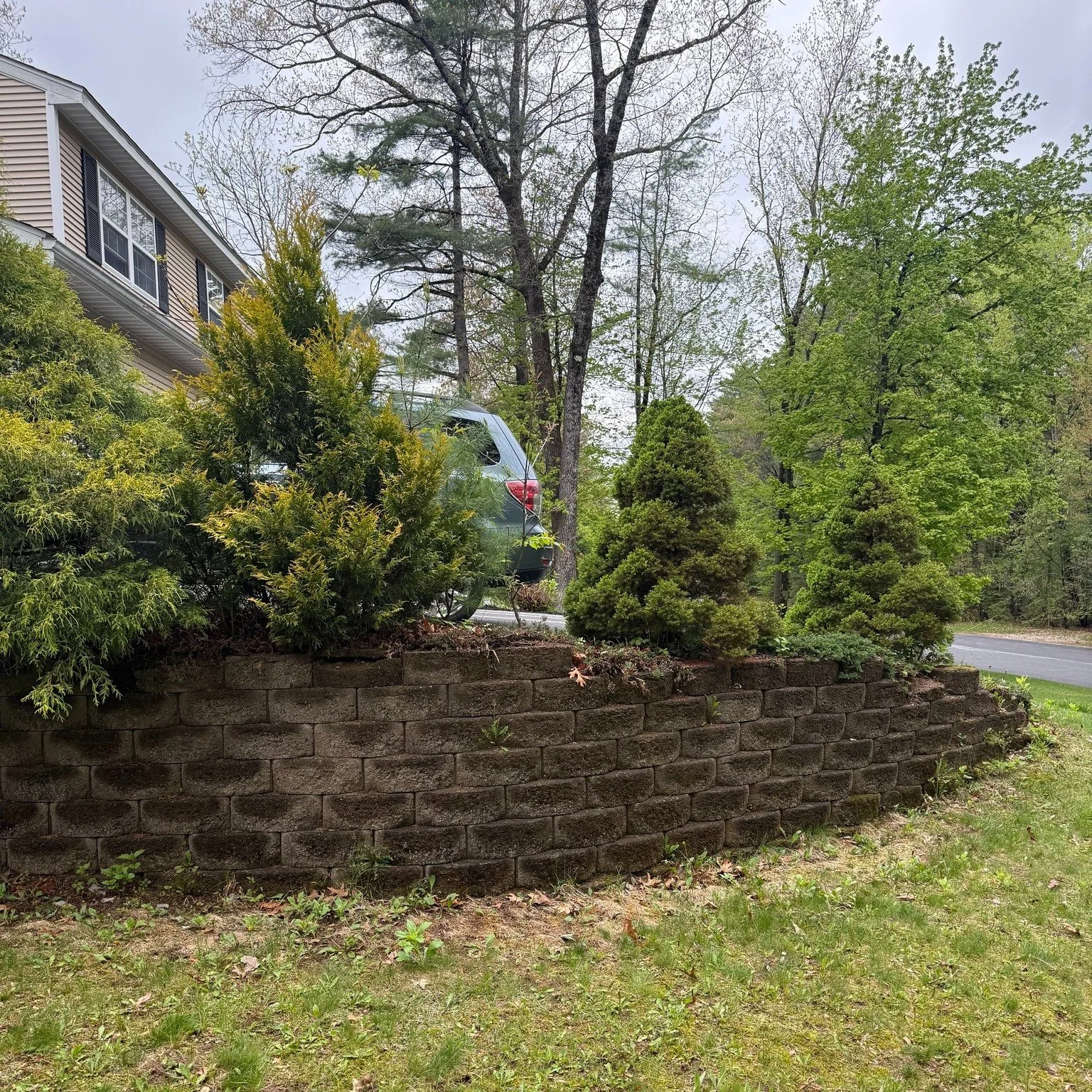 We installed this Versa-Lok retaining wall ahead of our customer's driveway replacement, and what a transformation already!