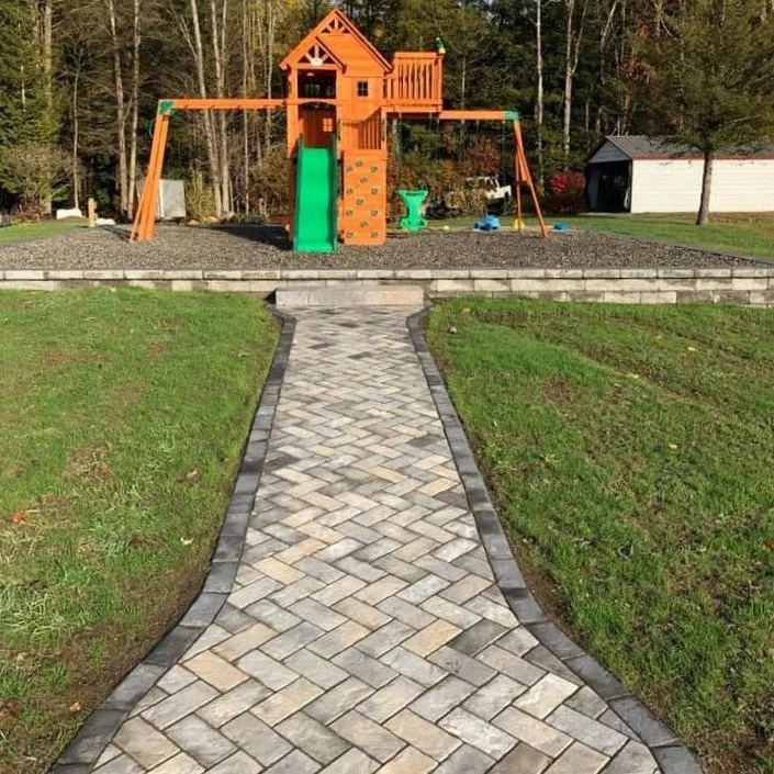 We installed this paver walkway leading to the playground, along with a small retaining wall to keep the play area contained and give it a clean, finished look.

Thinking about adding some hardscaping to your yard? Give us a call for a free estimate!