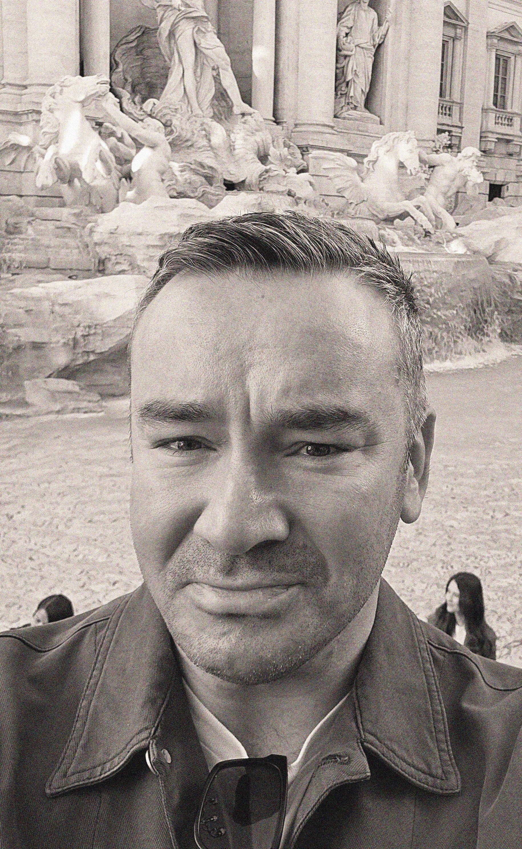 Very Strange founder Luke O’Neill beside a fountain.