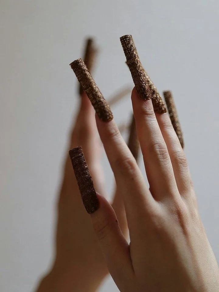 Temporal is about our future, how we see it, how we dream it,  and our future is full of thriving indiqueer baddies. 

These delicately woven red cedar nails are on display on a cast of the artist's hands. 

Ash Frantz (Makah)
adornment for an indigi